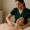 An esthetician applying a treatment to a woman’s neck and chest at Genesis Medspa.