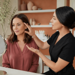 Provider discussing facial rejuvenation goals with a patient while using a handheld mirror.