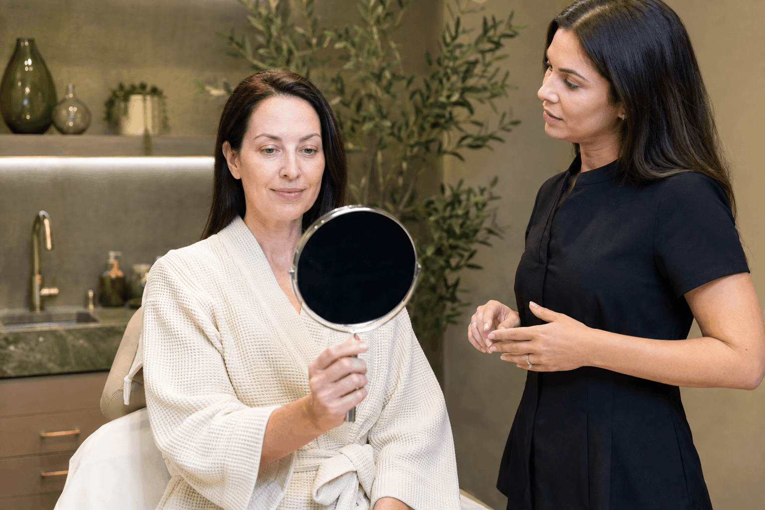 med spa provider assisting a client during a skin consultation
