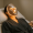A woman wearing an illuminated LED light therapy mask during treatment.
